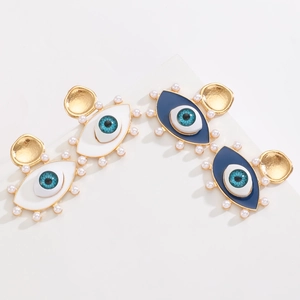 Close-up of evil eye hoop earrings with pearl edges and blue zircon insets