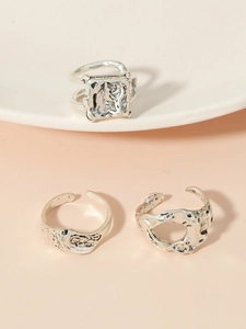 Detail view of silver hollow heart rings with vintage lava texture and open design