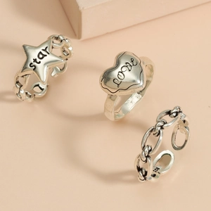 Detailed macro view of S925 sterling silver vintage rings with star and love heart engraving