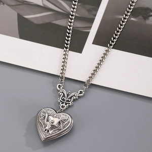 Vintage silver heart locket necklace with embossed floral detail and horse-hoof chain