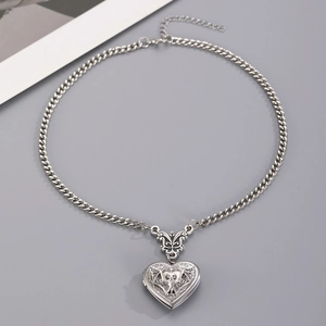 Gothic silver heart locket pendant featuring bat engraving and butterfly clasp detail