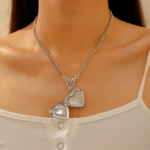 Vintage silver heart locket necklace for women featuring detailed floral relief engraving