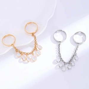 Detail of double ring with cubic zirconia water drop charms and delicate tassel chain