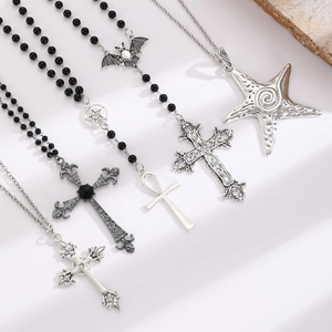 Gothic multilayer necklaces with cross pendants, black beads and starfish on white background