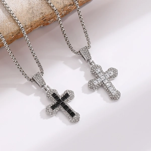 Close-up of iced-out cross pendants with zircon stones and silver box chains