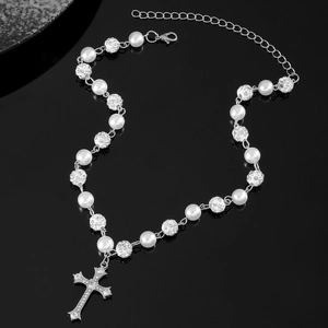 Macro detail of gothic beaded necklace featuring rhinestones and cross pendant