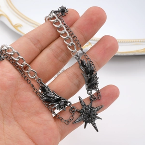 Detail of gothic multilayer necklace featuring black crystal wings and star pendant