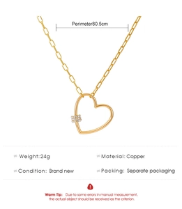 Détail d'un long collier coeur doré avec chaîne de 80,5 cm en cuivre et strass brillants