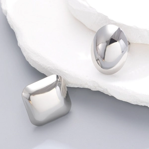 Macro shot of silver geometric minimalist rings with high-polish mirror finish on stones