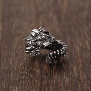 Gothic frog open ring with black gemstone eyes on rustic wood background