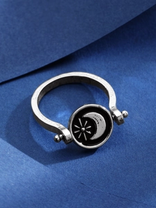 Dettaglio dell'anello rotante vintage con rilievo sole e luna in argento opaco