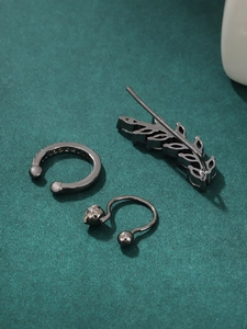 Detailed shot of gunmetal ear cuff set with micro-paved zircons on green background