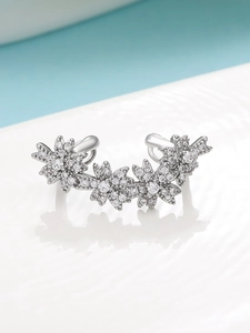 Detailed close-up of a silver floral ear cuff with micro-pave cubic zirconia crystals