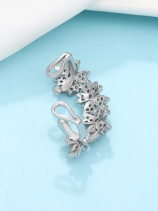 Macro shot of silver-toned ear cuff featuring five butterfly motifs set with black zircons