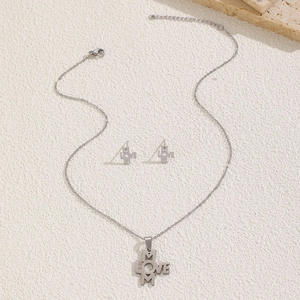 Silver stainless steel jewelry set featuring MOM and LOVE cross pendant and matching earrings