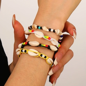 Bohemian four-piece braided bracelets with natural cowrie shells and colorful seed beads