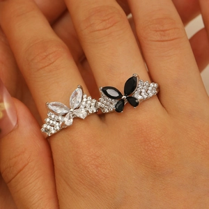Close-up of sparkling butterfly rings with black and white marquise-cut crystals