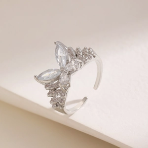 Macro shot of silver butterfly ring featuring sparkling zircon crystals and open band design