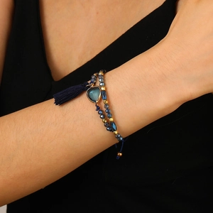 Bohemian handmade beaded bracelet with blue crystal beads, heart charm, and tassel accent