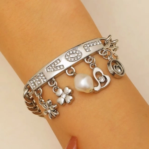Silver charm bracelet featuring LOVE lettering, pearl, hearts and flower pendants
