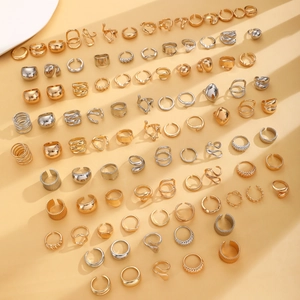Flachbild von minimalistischen Lava-Ringen in Gold und Silber auf beigem Hintergrund