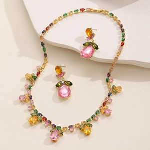 Elegant gold-plated jewelry set featuring colorful teardrop crystals and floral accents