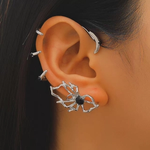 Detailed view of silver gothic spider earring and claw ear cuffs on model's ear