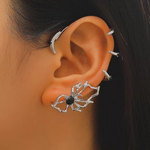 Macro shot of a gothic silver spider ear cuff set with a black gemstone on model