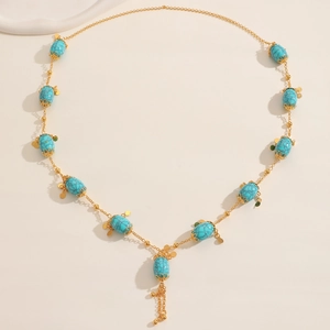 Bohemian gold long necklace with turquoise oval beads, floral spacers and tassel fringe