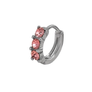 Close-up of silver huggie earring with three pink round zircons and polished finish