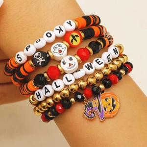 Detailed view of Halloween beaded bracelets with spooky letters and pumpkin charm