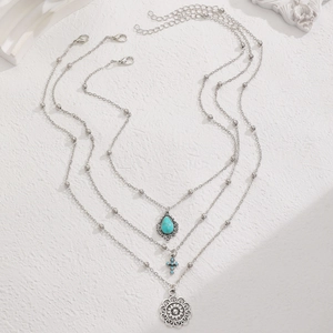 Detail of bohemian western cowboy necklace set with turquoise pendants and vintage silver finish