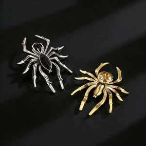 Detailed close-up showing spider brooch metal texture and secure back pin closure