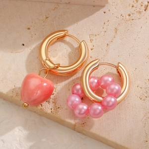 Asymmetric gold earrings with pink ceramic heart pendant and pearl bead accents