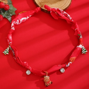 Détail du collier en soie rouge pour animaux avec pendentifs de Noël dorés