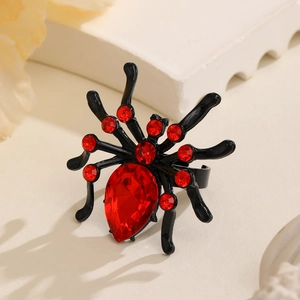 Close-up of gothic spider ring with deep red pear-cut rhinestone and black metal finish