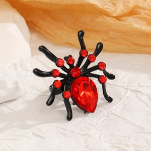 Close-up of gothic spider ring with large red teardrop gem and black lacquer finish