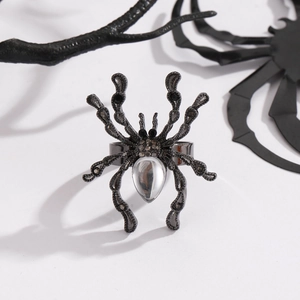 Macro shot of gothic spider ring with clear teardrop crystal on dark alloy band