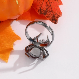 Macro shot of gothic spider ring in gunmetal finish with pumpkin and maple leaf background