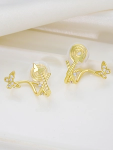 Macro detail of golden butterfly clip-on earrings with pave-set sparkling zircon stones