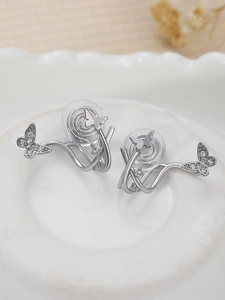 Close-up of butterfly clip-on earrings with shimmering zircons and soft silicone pads