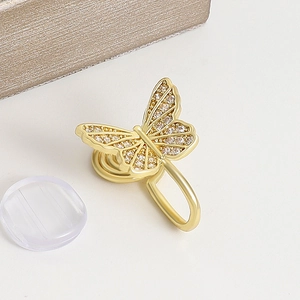 Detailed macro view of a gold-plated butterfly clip earring with sparkling zircon stones