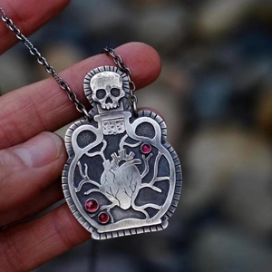 Gothic skull potion bottle necklace with anatomical heart and red crystal stones