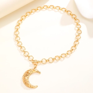 Dettaglio macro della collana con pendente a luna dorata con chiusura OT e trama martellata