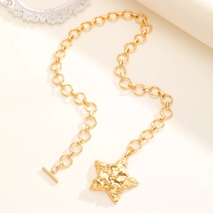 Dettaglio della collana a catena dorata con ciondolo a stella martellata e chiusura OT