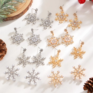 Elegant snowflake earrings with pearls and diamonds set against festive Christmas decor