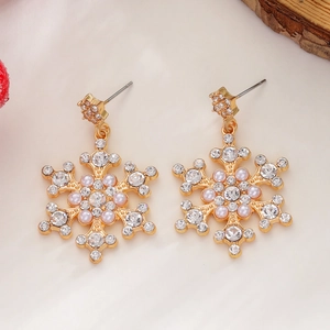 Detailed view of luxury snowflake earrings with diamonds and pink pearls on soft fur