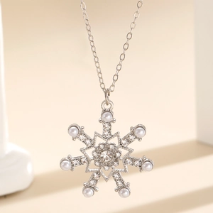 Macro view of silver snowflake pendant necklace with cubic zirconia and white pearls
