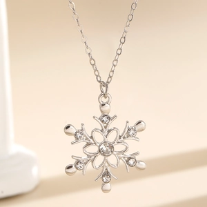 Macro view of silver snowflake pendant necklace with sparkling zircon crystals and fine chain