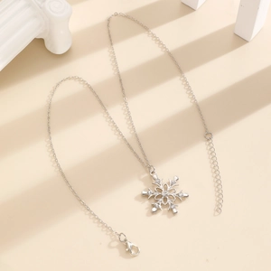 Macro view of silver snowflake pendant with sparkling rhinestones on a decorative pedestal